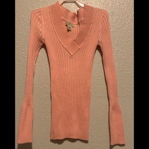 I’m selling a Coral, Black and Cream sweater.